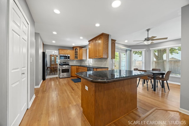 1630 Lois Ann Ln, Naperville, IL 60563 - kitchen with stainless steel appliances, brown cabinets, glass insert cabinets, light wood-style flooring, and recessed lighting