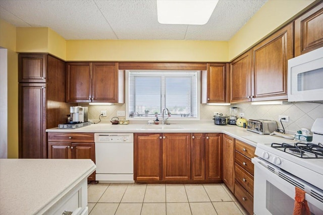 770 Pearson St Unit 604, Des Plaines, IL 60016 - kitchen featuring white appliances, a sink, tasteful backsplash, light countertops, and light tile patterned floors