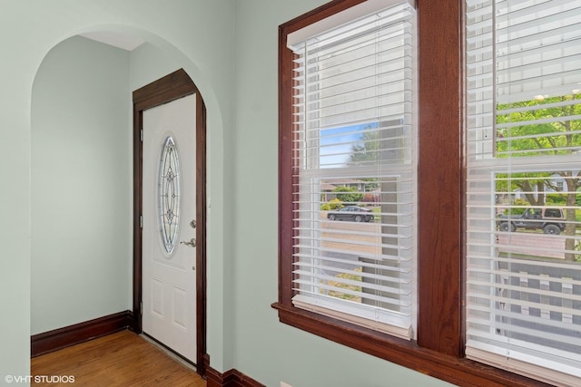 420 Blackhawk Dr, Westmont, IL 60559 - foyer entrance with arched walkways, wood finished floors, and baseboards