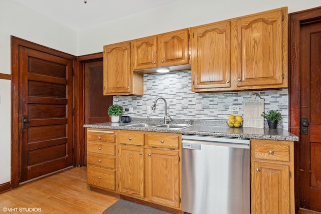 420 Blackhawk Dr, Westmont, IL 60559 - kitchen featuring dishwasher, a sink, decorative backsplash, light wood-style flooring, and brown cabinetry