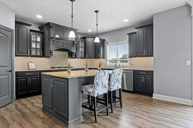 4 Emerald Crest Ct, Bloomington, IL 61705 - kitchen with stainless steel appliances, a center island, glass insert cabinets, wood finished floors, and recessed lighting