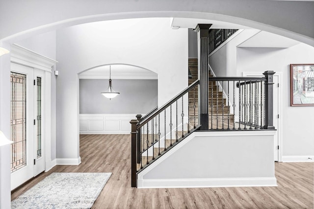 4 Emerald Crest Ct, Bloomington, IL 61705 - entryway featuring wood finished floors, stairs, crown molding, and arched walkways