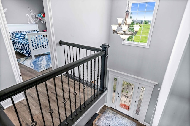 4 Emerald Crest Ct, Bloomington, IL 61705 - staircase featuring a chandelier and wood finished floors