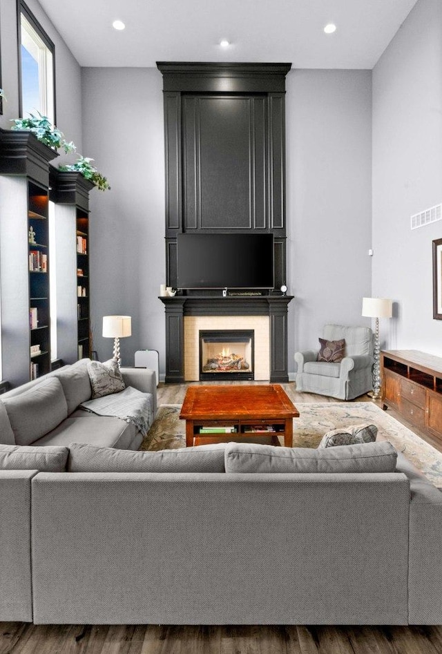 4 Emerald Crest Ct, Bloomington, IL 61705 - living area featuring wood finished floors, a lit fireplace, and recessed lighting