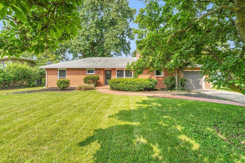 70 Greencroft Dr, Champaign, IL 61821 - ranch-style house with asphalt driveway, brick siding, a front yard, and a garage