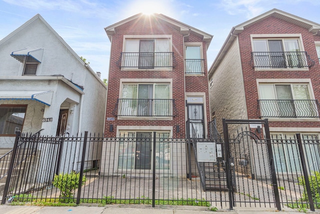 6344 S Rhodes Ave, Chicago, IL 60637 - view of front facade with a fenced front yard, brick siding, and a gate
