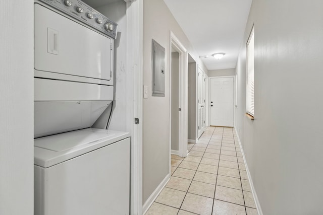 6344 S Rhodes Ave, Chicago, IL 60637 - laundry room with stacked washer / dryer, light tile patterned flooring, baseboards, and electric panel