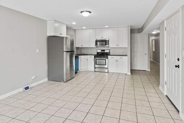 6344 S Rhodes Ave, Chicago, IL 60637 - kitchen with appliances with stainless steel finishes, baseboards, dark countertops, tasteful backsplash, and white cabinetry