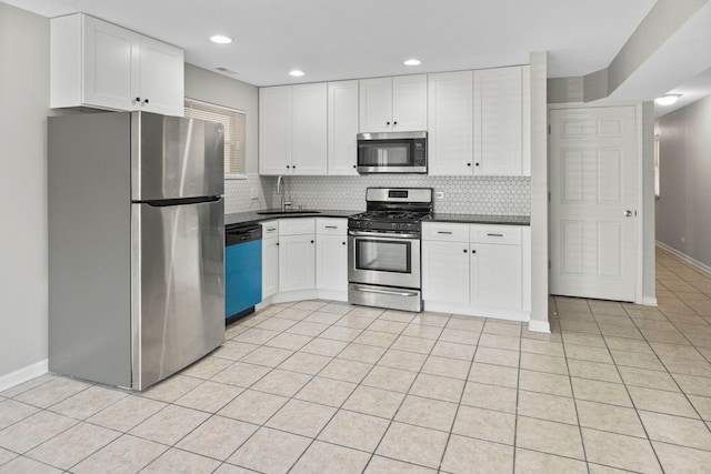 6344 S Rhodes Ave, Chicago, IL 60637 - kitchen featuring appliances with stainless steel finishes, a sink, dark countertops, backsplash, and white cabinetry
