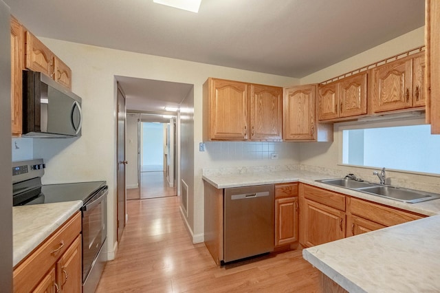 6545 Main St Unit 408, Downers Grove, IL 60516 - kitchen with appliances with stainless steel finishes, a sink, light wood-type flooring, and light countertops