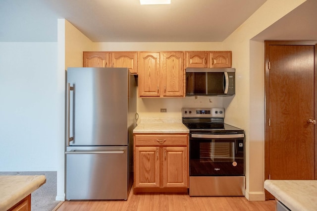 6545 Main St Unit 408, Downers Grove, IL 60516 - kitchen featuring stainless steel appliances, light countertops, and light wood-style floors