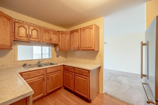 6545 Main St Unit 408, Downers Grove, IL 60516 - kitchen featuring a sink, high end refrigerator, light countertops, light wood-type flooring, and brown cabinetry