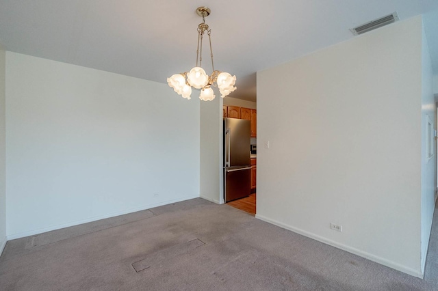 6545 Main St Unit 408, Downers Grove, IL 60516 - empty room featuring a chandelier, light carpet, and baseboards
