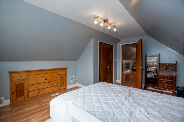 5936 S Keeler Ave, Chicago, IL 60629 - bedroom featuring wood finished floors, lofted ceiling, baseboards, and a closet