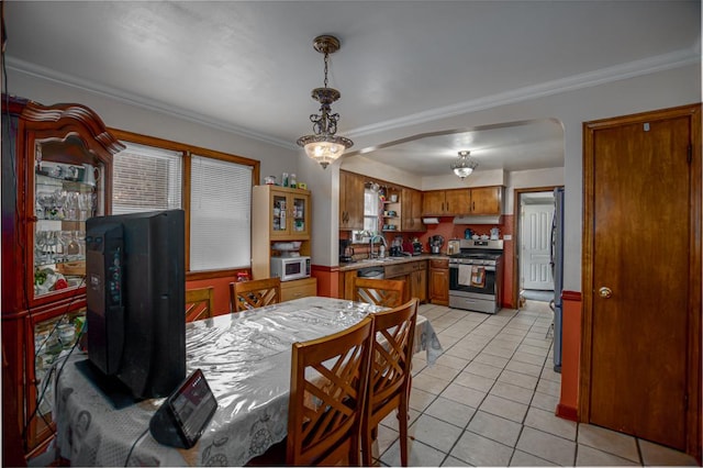5936 S Keeler Ave, Chicago, IL 60629 - dining room with arched walkways, ornamental molding, light tile patterned floors, and healthy amount of natural light