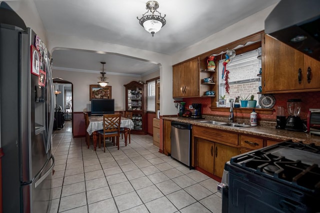 5936 S Keeler Ave, Chicago, IL 60629 - kitchen with dishwasher, arched walkways, fridge with ice dispenser, a sink, and gas range oven