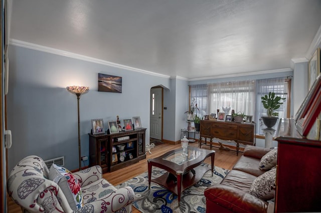 5936 S Keeler Ave, Chicago, IL 60629 - living room featuring arched walkways, crown molding, wood finished floors, and baseboards