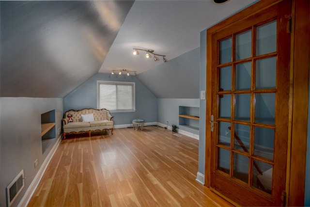 5936 S Keeler Ave, Chicago, IL 60629 - additional living space with light wood-style floors, baseboards, built in features, and vaulted ceiling