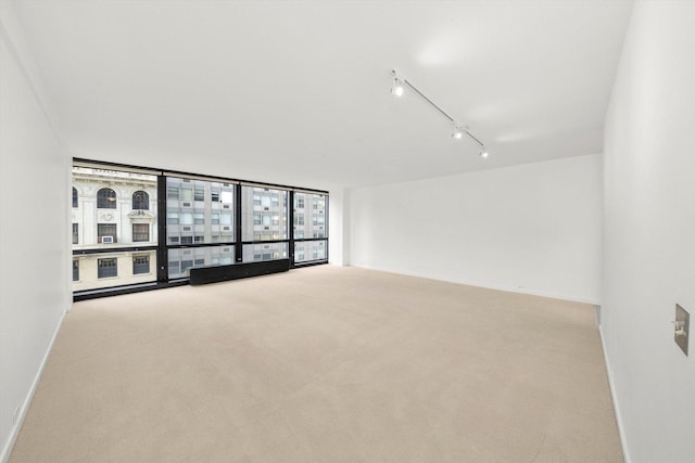 900 N Lake Shore Dr Unit 1104, Chicago, IL 60611 - spare room featuring carpet floors, baseboards, and track lighting