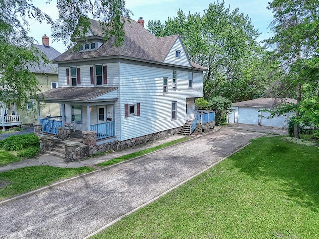 645 E Calhoun St, Woodstock, IL 60098 - traditional style home with covered porch, an outbuilding, a garage, a front yard, and a chimney