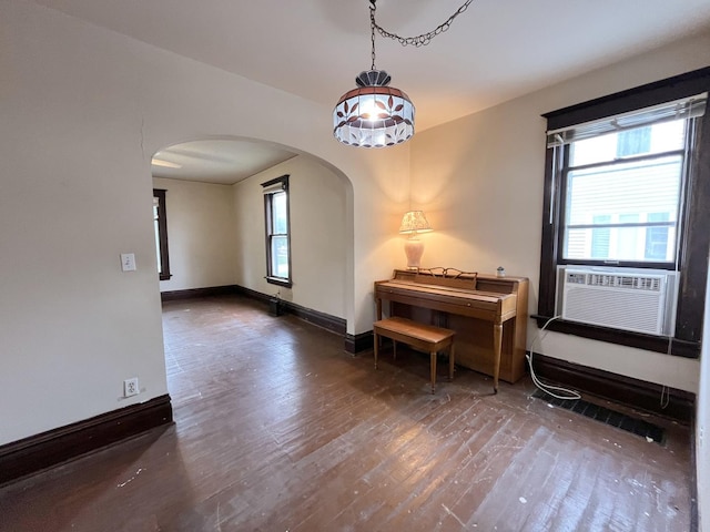 645 E Calhoun St, Woodstock, IL 60098 - living area featuring arched walkways, wood finished floors, and cooling unit