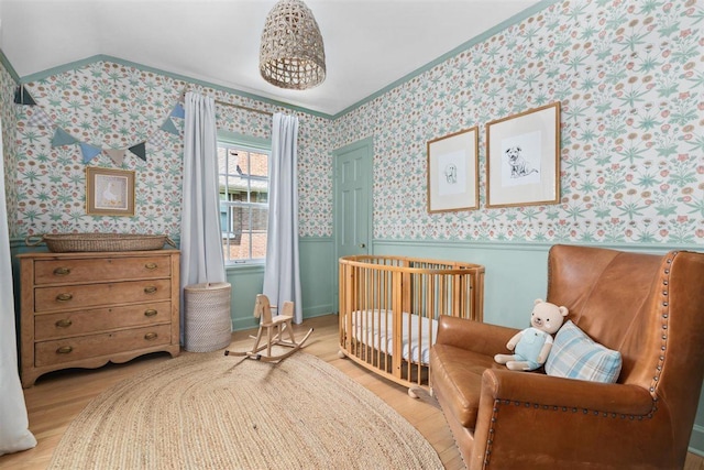 2133 Birchwood Ave, Wilmette, IL 60091 - bedroom featuring light wood-style flooring, a wainscoted wall, wallpapered walls, a crib, and ornamental molding