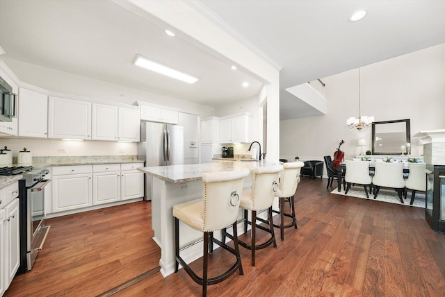 2730 Lorraine Cir, Geneva, IL 60134 - kitchen with stainless steel appliances, a chandelier, white cabinets, dark wood finished floors, and recessed lighting