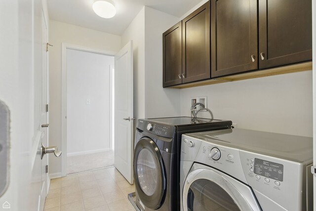 652 Grosvenor Ln, Aurora, IL 60504 - laundry area with cabinet space, washer and clothes dryer, and baseboards