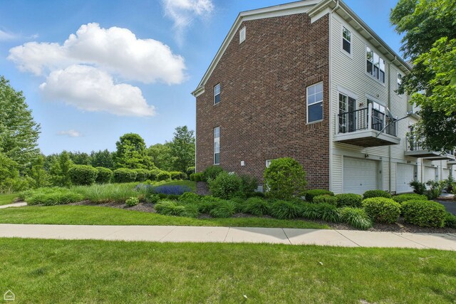 652 Grosvenor Ln, Aurora, IL 60504 - view of property exterior featuring brick siding, a lawn, and a garage
