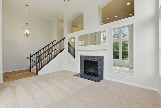 652 Grosvenor Ln, Aurora, IL 60504 - unfurnished living room featuring carpet flooring, stairs, a chandelier, baseboards, and a high ceiling