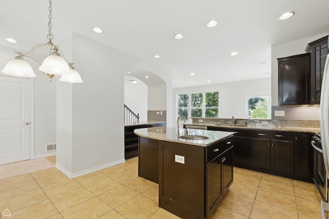 652 Grosvenor Ln, Aurora, IL 60504 - kitchen featuring a sink, light tile patterned flooring, light stone countertops, recessed lighting, and a chandelier