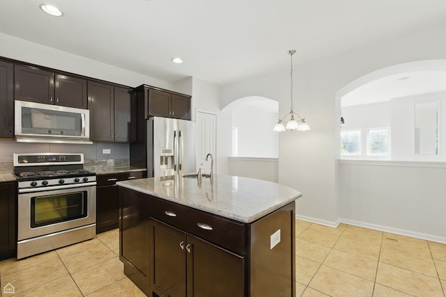 652 Grosvenor Ln, Aurora, IL 60504 - kitchen with appliances with stainless steel finishes, light tile patterned floors, tasteful backsplash, arched walkways, and recessed lighting