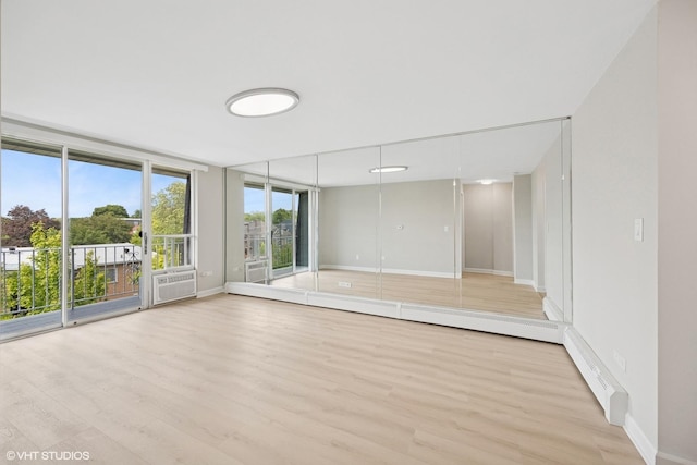 415 Wesley Ave Unit 45, Oak Park, IL 60302 - unfurnished room with wood finished floors, baseboards, and a baseboard radiator