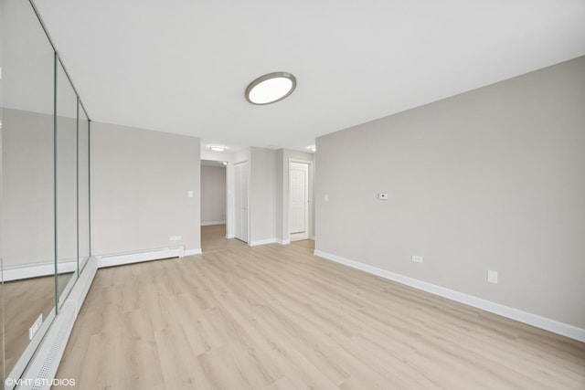 415 Wesley Ave Unit 45, Oak Park, IL 60302 - empty room with light wood-style floors, baseboards, and a baseboard heating unit