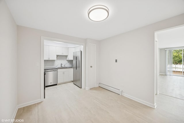 415 Wesley Ave Unit 45, Oak Park, IL 60302 - unfurnished living room with a baseboard radiator, a sink, baseboards, and light wood-type flooring