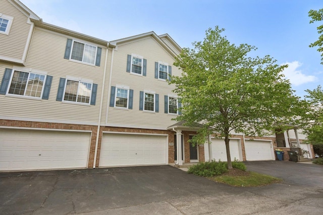 1911 Indian Hill Ln, Aurora, IL 60503 - view of property with brick siding, driveway, and an attached garage