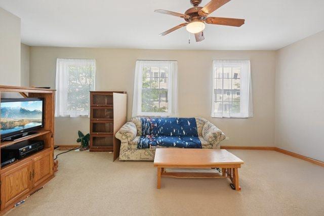 1911 Indian Hill Ln, Aurora, IL 60503 - living area with plenty of natural light, a ceiling fan, and light carpet