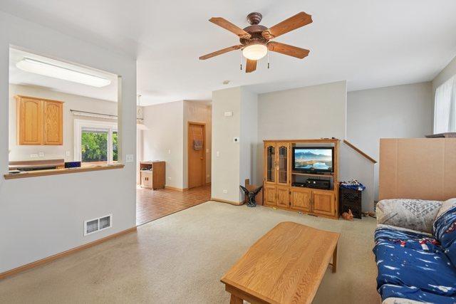 1911 Indian Hill Ln, Aurora, IL 60503 - living area featuring ceiling fan and baseboards