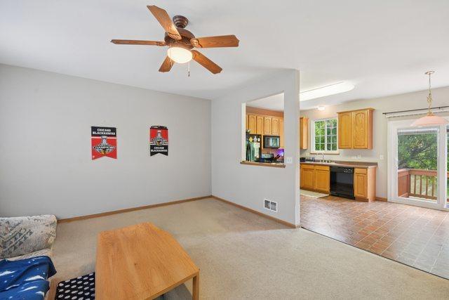 1911 Indian Hill Ln, Aurora, IL 60503 - living room featuring ceiling fan and light carpet
