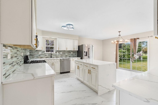 933 Tralee Ct, Gurnee, IL 60031 - kitchen with stainless steel appliances, light marble finish flooring, a chandelier, backsplash, and a sink