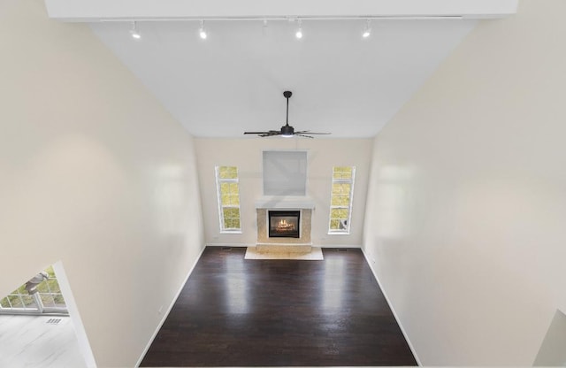 933 Tralee Ct, Gurnee, IL 60031 - unfurnished living room with rail lighting, plenty of natural light, a ceiling fan, and vaulted ceiling