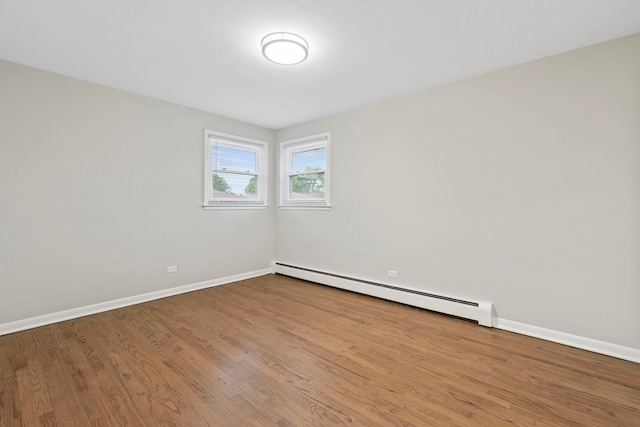 6964 W Diversey Ave Unit 7, Chicago, IL 60707 - spare room featuring baseboard heating, wood finished floors, and baseboards