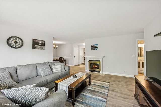 2980 Northampton Dr Unit A2, Rolling Meadows, IL 60008 - living room with light wood finished floors, a chandelier, baseboards, and a fireplace with flush hearth