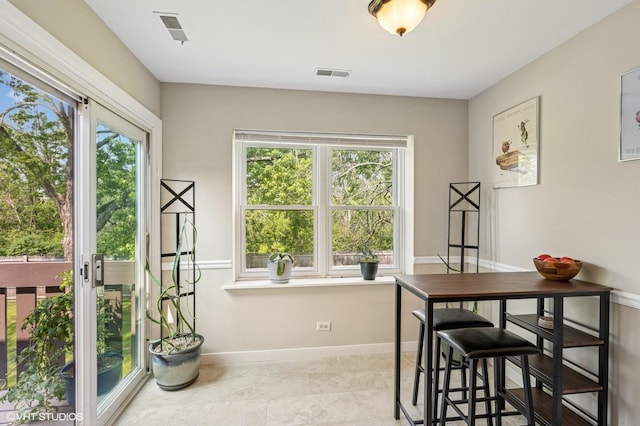 2980 Northampton Dr Unit A2, Rolling Meadows, IL 60008 - dining room featuring plenty of natural light and baseboards