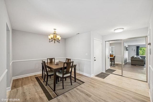 2980 Northampton Dr Unit A2, Rolling Meadows, IL 60008 - dining room with light wood finished floors, a chandelier, and baseboards