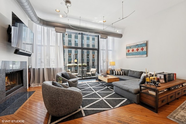 333 W Hubbard St Unit 708, Chicago, IL 60654 - living area featuring hardwood / wood-style floors, a fireplace, and expansive windows