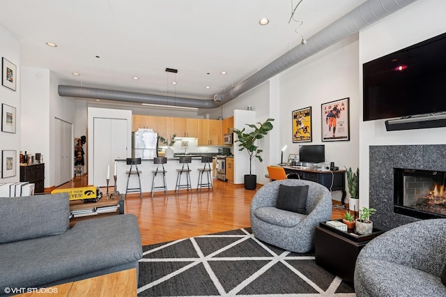 333 W Hubbard St Unit 708, Chicago, IL 60654 - living area with light wood finished floors, a high end fireplace, and recessed lighting