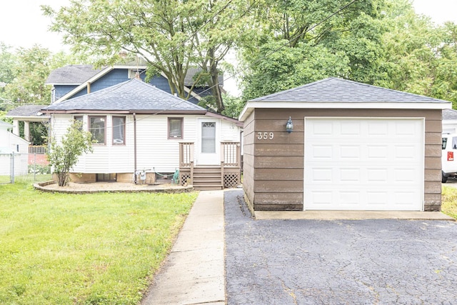 359 Elm St, Elgin, IL 60123 - view of front of home featuring a shingled roof, asphalt driveway, a garage, and an outbuilding