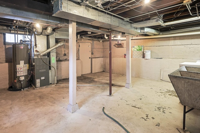359 Elm St, Elgin, IL 60123 - below grade area featuring gas water heater, heating unit, and a sink