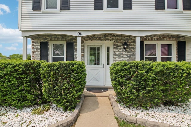 104 S Walnut Ln, Schaumburg, IL 60193 - view of exterior entry featuring stone siding and covered porch